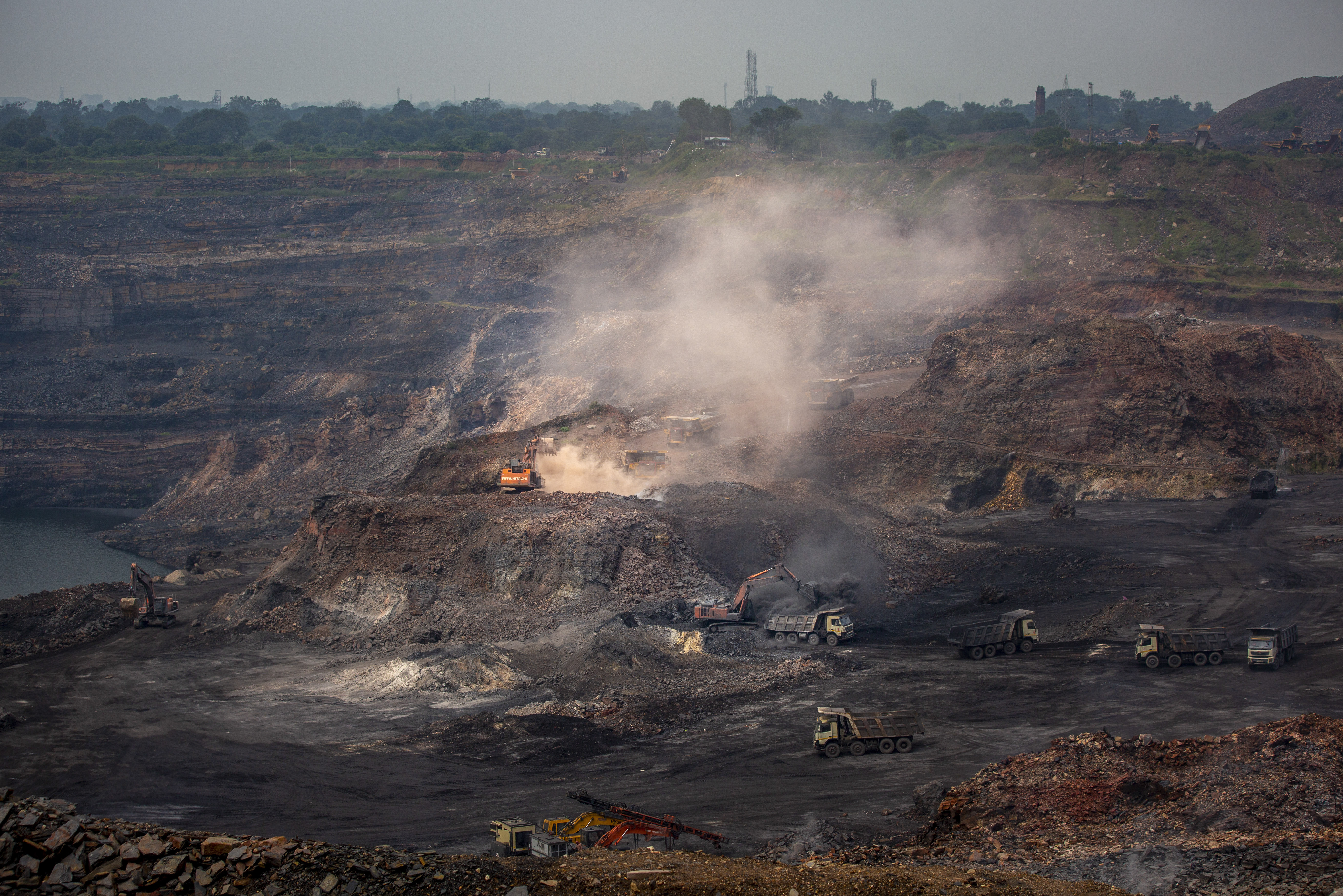 Mining is in progress at an open-cast mine near Dhanbad, an eastern Indian city in Jharkhand state, Friday, Sept. 24, 2021.
