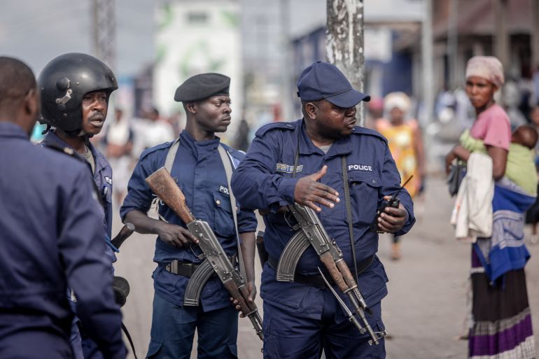 Police officers discuss a strategy to disperse demonstrators during a demonstration in Goma, eastern Democratic Republic of Congo.