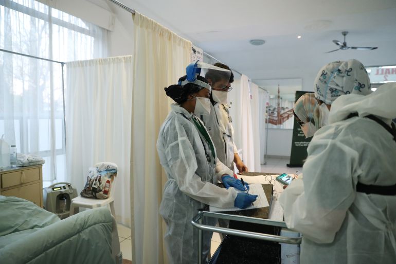Healthcare workers assist patients being treated at a makeshift hospital in Johannesburg.