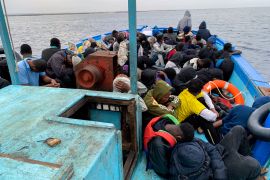 Migrants are seen in a boat as they were picked up by Libyan Coast Guards in the Mediterranean Sea, off the coast of Libya on October 18, 2021 [File: Reuters/Ayman Al-Sahili]