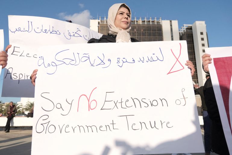 A woman holds a banner during a protest