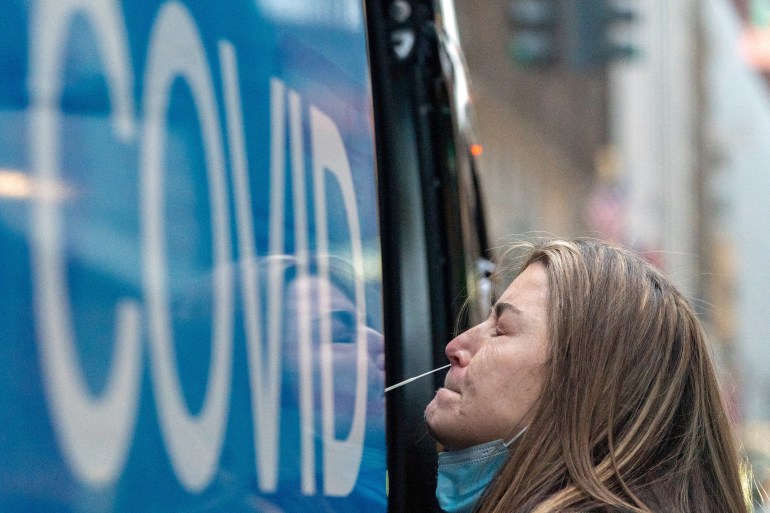 A woman takes a COVID-19 test at a pop-up testing site in Manhattan, New York