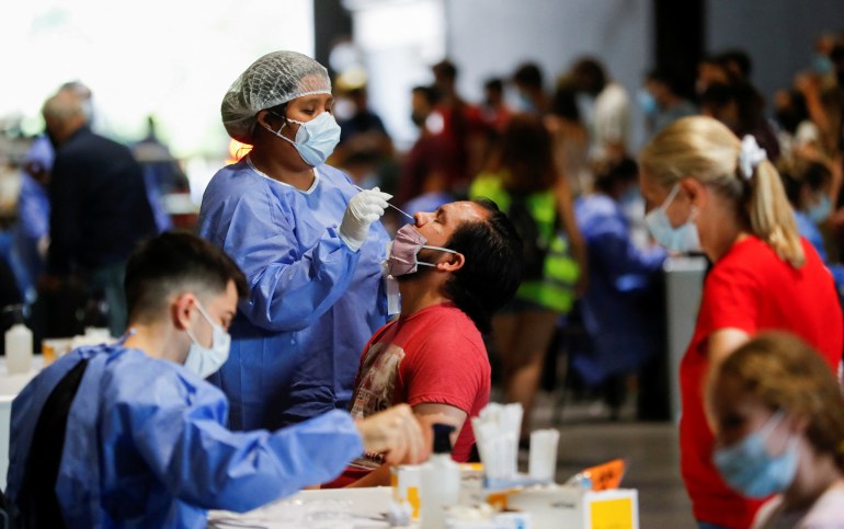 A healthcare worker takes a swab sample from a man to be tested for COVID-19 in Buenos Aires, Argentina 