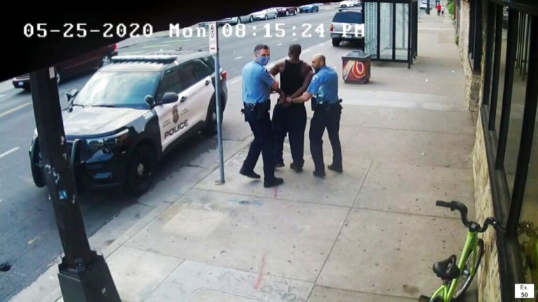This image from video shows Minneapolis police Officers Thomas Lane, left and J. Alexander Kueng, right, escorting George Floyd, center, to a police vehicle outside Cup Foods in Minneapolis, on May 25, 2020.