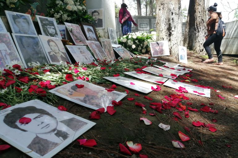 Photographs of the disappeared sprinkled with rose petals at memorial site