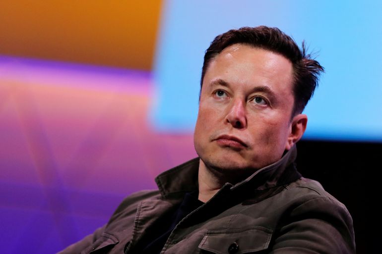 Elon Musk listens during a conference.