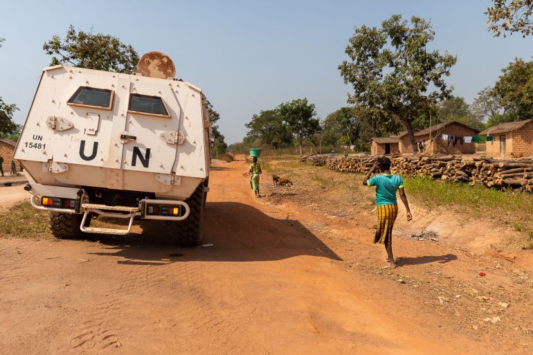A United Nations (UN) armoured personnel carrier patrols a supposedly safe road, avoiding roads with possible explosive devices on them, in Paoua, on December 5, 2021. - In the north-west of the Central African Republic, where fighting regularly pits the military against armed groups, the rebels have hidden numerous explosive devices on the roads, killing civilians and paralysing humanitarian action. (Photo by Barbara DEBOUT/AFP)