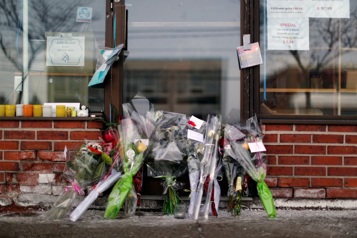 Flowers are pictured at the door to the grocery store owned by Azzedine Soufiane, killed in the mosque attack
