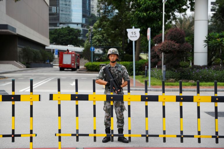 A soldier standing at the gates of the PLA garrison in Hong Kong
