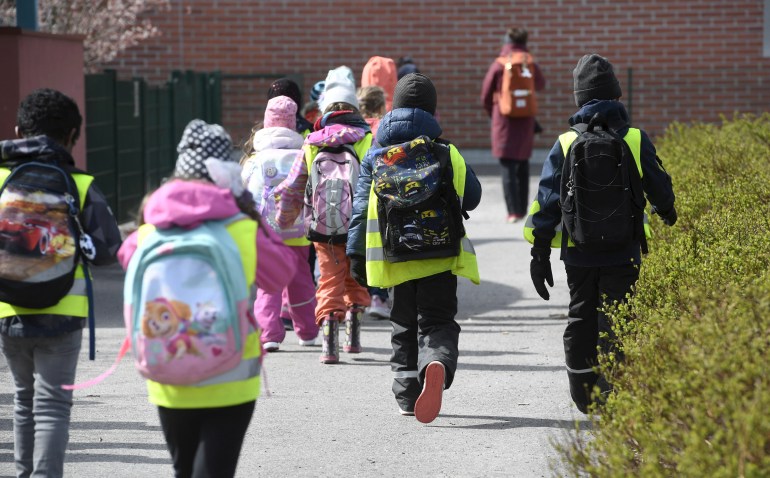  Pupils walk towards Kirsti primary school as it reopens after after eight weeks of lockdown due to the coronavirus