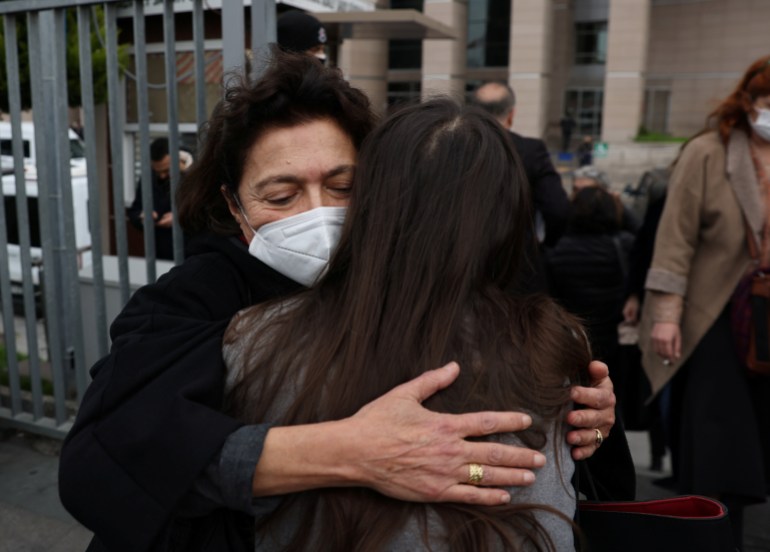 Ayse Bugra, wife of philanthropist Osman Kavala, hugs a friend as she leaves the courthouse after a hearing of Osman Kavala and 15 others over their role in nationwide protests in 2013, in Istanbul, Turkey, 