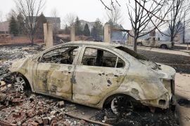 Remains of buildings and cars damaged by wildfires in Superior, Colorado