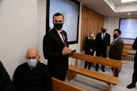 Former Israeli Prime Minister Ehud Olmert, former Israeli Prime Minister Benjamin Netanyahu and his wife Sara attend a preliminary hearing of the defamation lawsuit