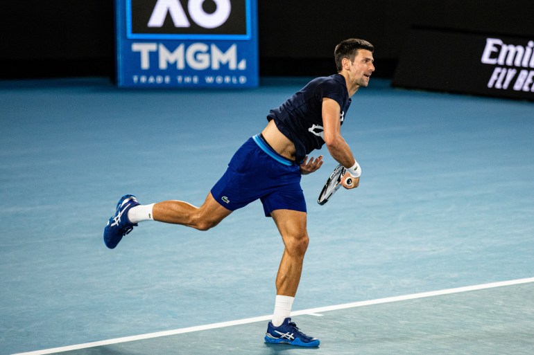Novak Djokovic in blue shorts, t-shorts and shoes plays a shot during practise at Melbourne Park