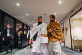 Representatives of the Taliban walk at the Soria Moria hotel