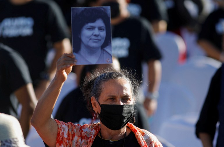 Woman holding picture of relative killed during coup