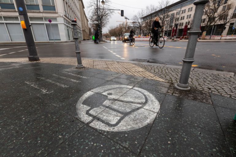 A protective mask mural on a sidewalk in Berlin, Germany