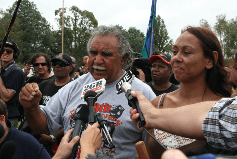 Ghillar Michael Anderson speaking to journalists outside outside the Aboriginal Tent Embassy.