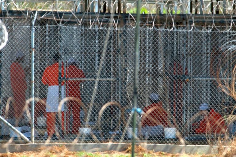 Detainees in orange jumpsuits at Guantanamo Bay