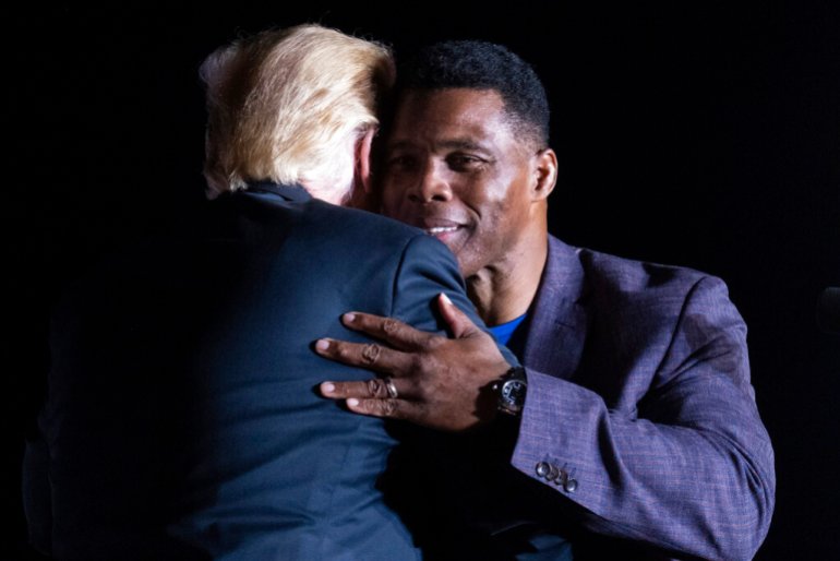 ormer President Donald Trump hugs Georgia Senate candidate Herschel Walker during his Save America rally.
