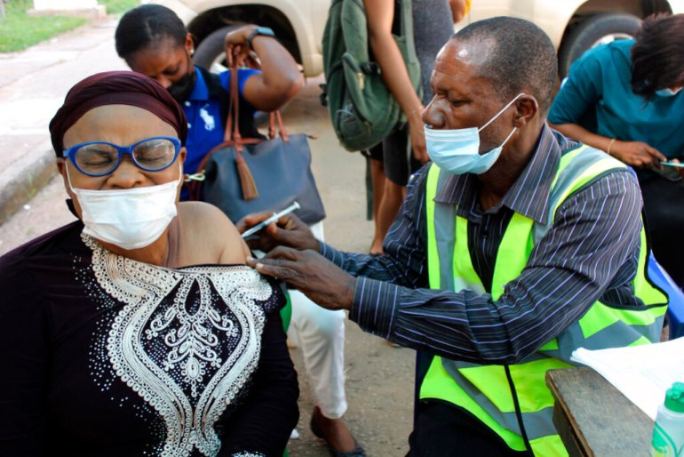 A woman receives a coronavirus vaccine jab in Abuja, Nigeria,