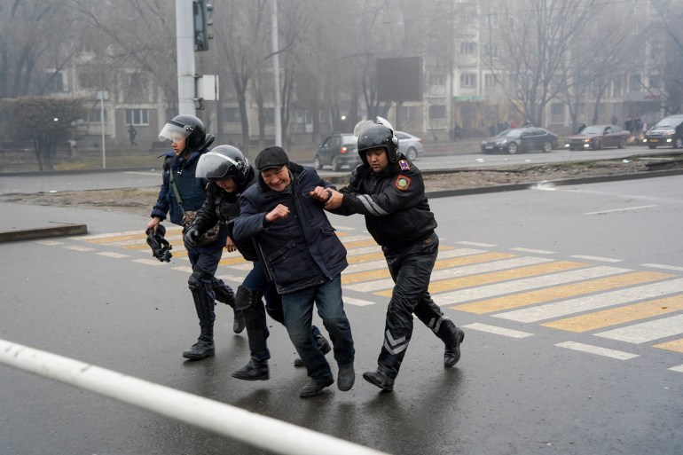 Police officers detain a demonstrator during a protest in Almaty, Kazakhstan