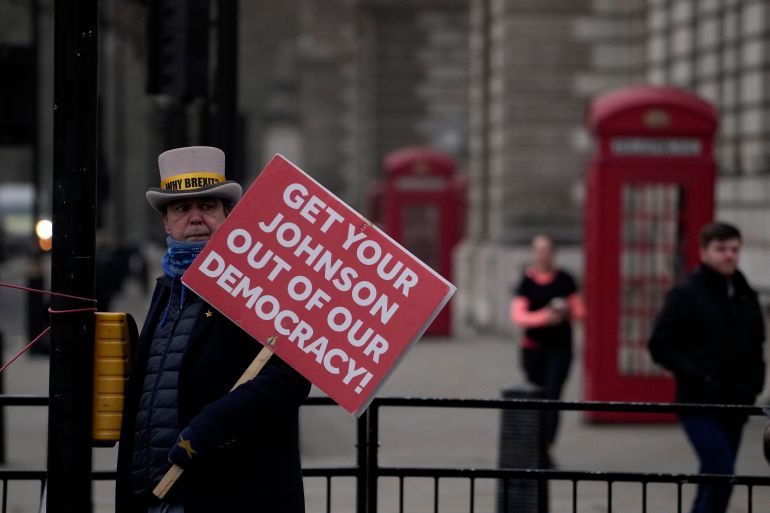 Protester holding an anti-Boris Johnson sign