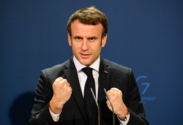 French President Emmanuel Macron gestures as he speaks during a media conference