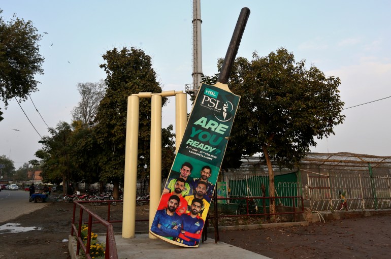 Huge wickets and a bat, with the pictures of cricket players display near the Gaddafi Stadium pakistan