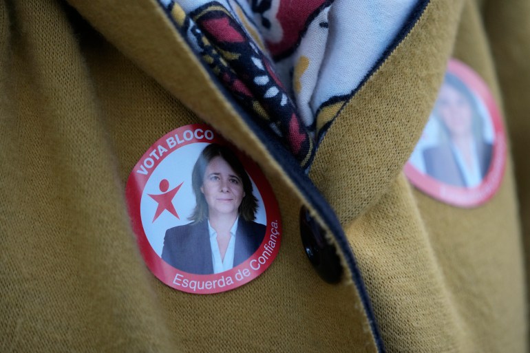 A woman wears stickers with a picture of Left Bloc leader Catarina Martins 