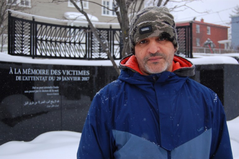 Mohamed Khabar, a Quebec mosque attack survivors, poses in front of a memorial to the victims