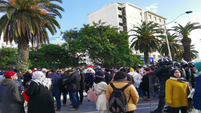 Tunisians rally in front of security forces in downtown Tunis on Friday