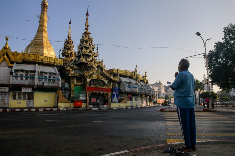 A man prays outside Yangon's landmark Sule Pagoda in the early hours of February 1 when the military seized power