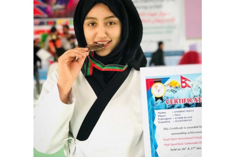 Anzorat Wali, 19, poses with her medal and certificate.