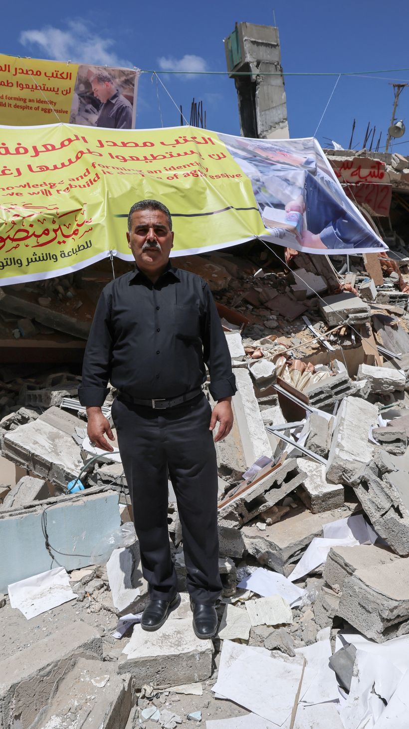 A man stands in the rubble of a destroyed bookstore in Gaza