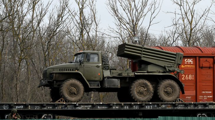 Russian military vehicles are seen loaded on train platforms some 50 km off the border with the self-proclaimed Donetsk People's Republic