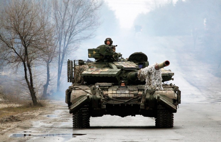 Ukrainian servicemen are seen riding on tanks towards the front line with Russian forces in the Luhansk region of Ukraine