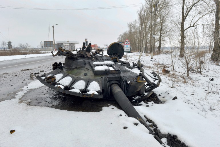 A fragment of a destroyed Russian tank is seen on the roadside on the outskirts of Kharkiv