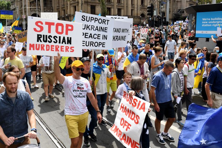People attend a march to protest against the Russian invasion of Ukraine, in Melbourne