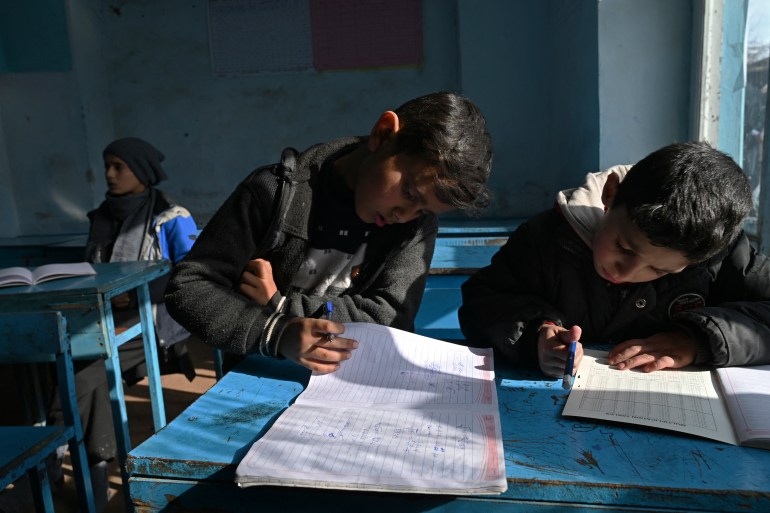 Students take a lesson at a private school on the outskirts of Kabul