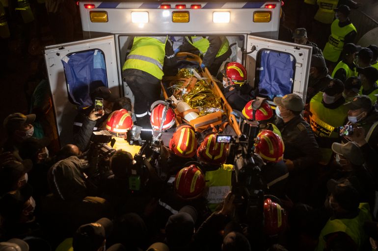 Moroccan emergency services teams carry five-year-old Rayan Oram into an ambulance