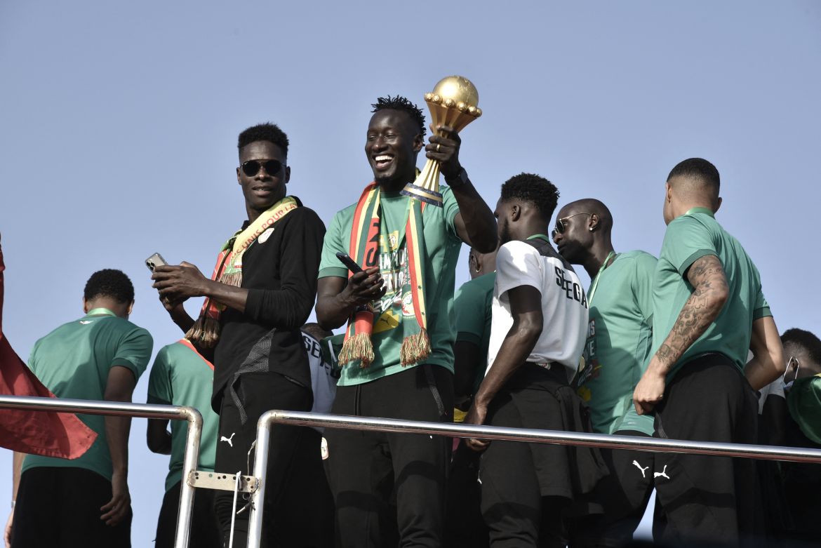 Senegal striker Famara Diedhiou holds the trophy of the Africa Cup of Nations
