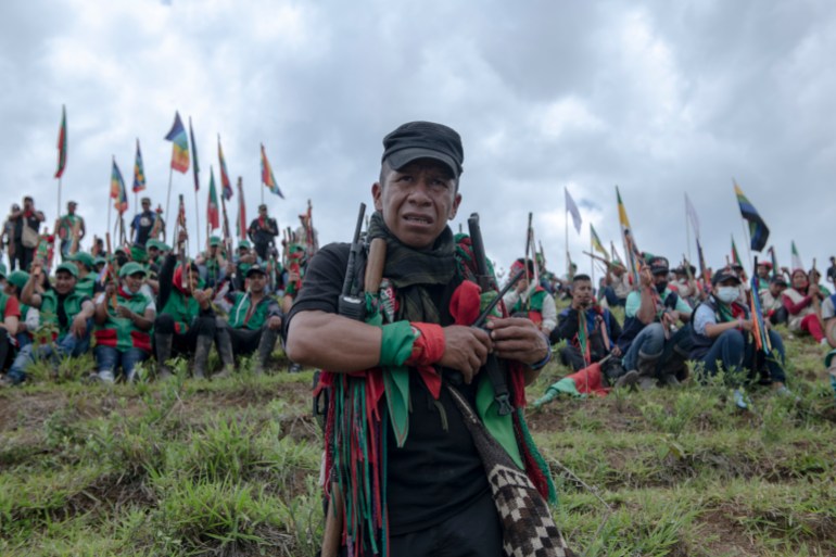 José Albeiro Camayo (42), one of the leaders of the indigenous guard, observes the event.