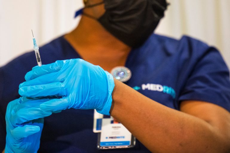 Medical staffer prepares vaccine dose