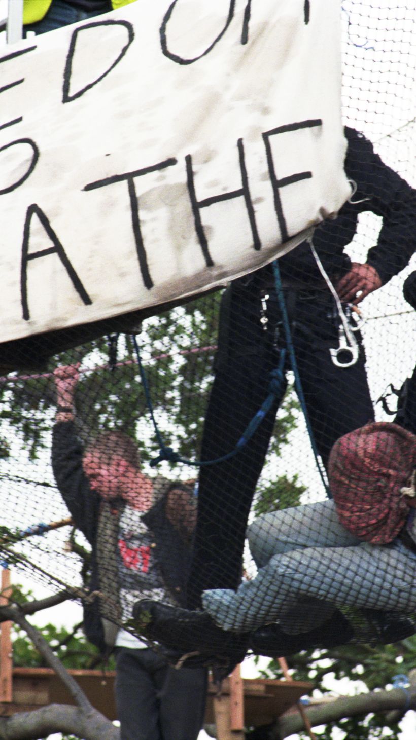 A protestor is tackled in a mesh net in East London
