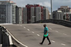 A man walks at Americas avenue at Barra da Tijuca neighborhood