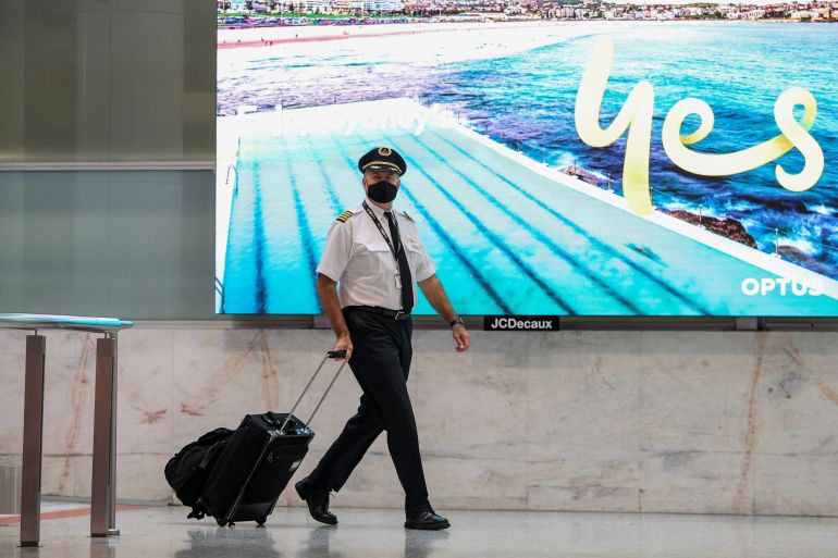 A flight crew member arrives at the international terminal at Sydney Airport in Australia, November 30, 2021.
