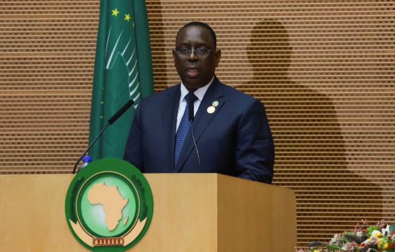 Senegal's President Macky Sall standing at a podium