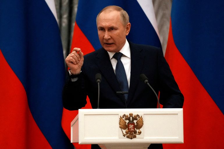 Russian President Vladimir Putin gestures during a press conference with French President Emmanuel Macron, in Moscow.