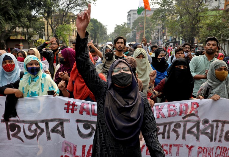 A Muslim student shouts slogans as she takes part in a protest against the recent hijab ban in few colleges of Karnataka state, in Kolkata, India